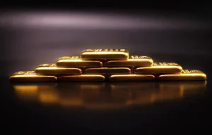 Stacked gold bars representing gold as a safe-haven investment asset 